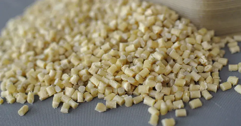 Granulés en plastique blanc cassé sur fond gris