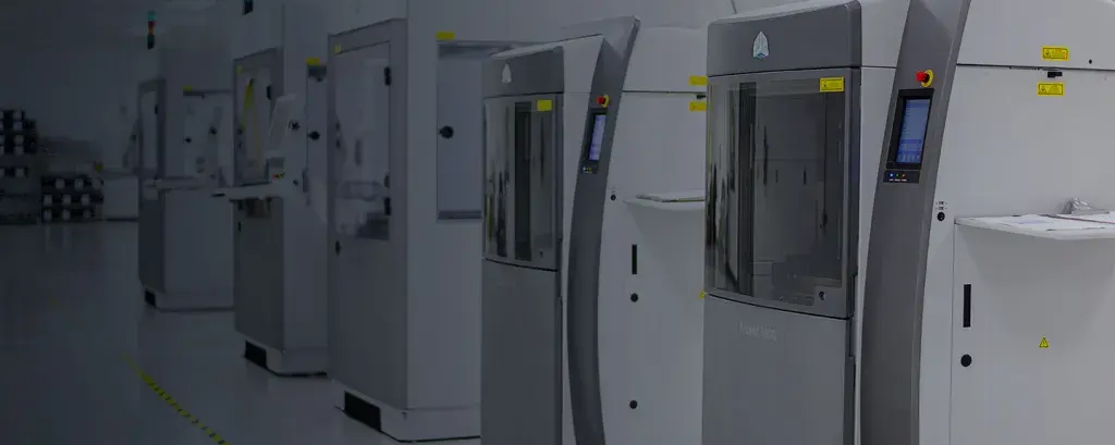 a row of 3D printers in a facility