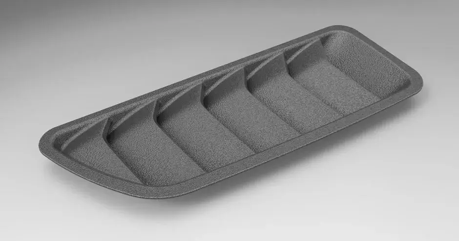 Une calandre « requin » en plastique imprimée en 3D avec une qualité de niveau production et une finition de surface texturée.