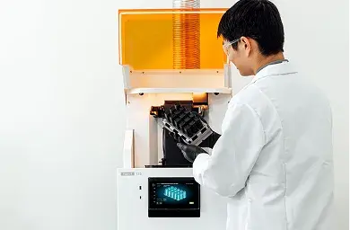 Man working in a lab with a 3D printer